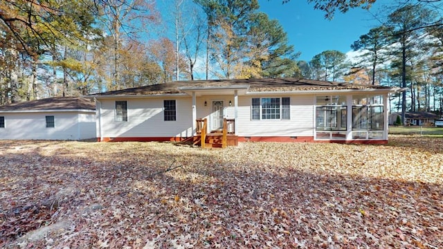 rear view of property with a sunroom