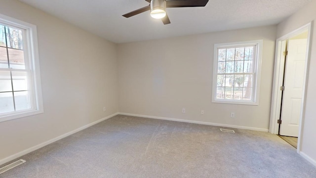 unfurnished room featuring ceiling fan and light colored carpet