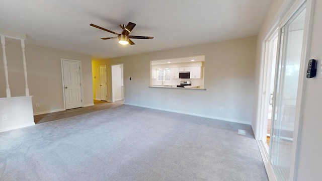 unfurnished living room featuring carpet flooring and ceiling fan