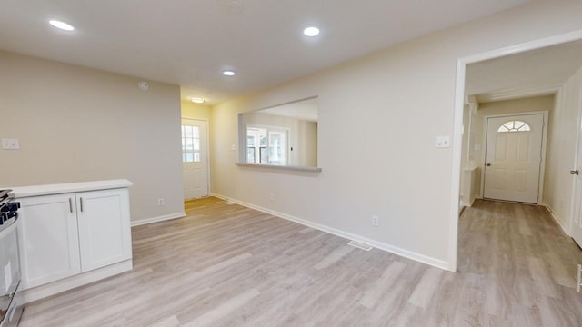 unfurnished dining area with light hardwood / wood-style floors