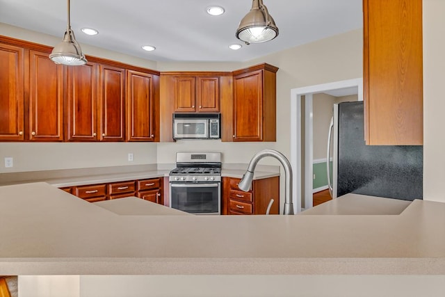kitchen with recessed lighting, appliances with stainless steel finishes, pendant lighting, and a sink