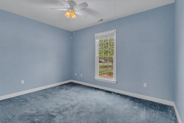 carpeted empty room with baseboards, ceiling fan, and visible vents