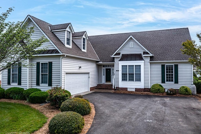 48 Old Field Rd, Irvington, VA 22480 - new england style home featuring driveway, an attached garage, a shingled roof, and a standing seam roof