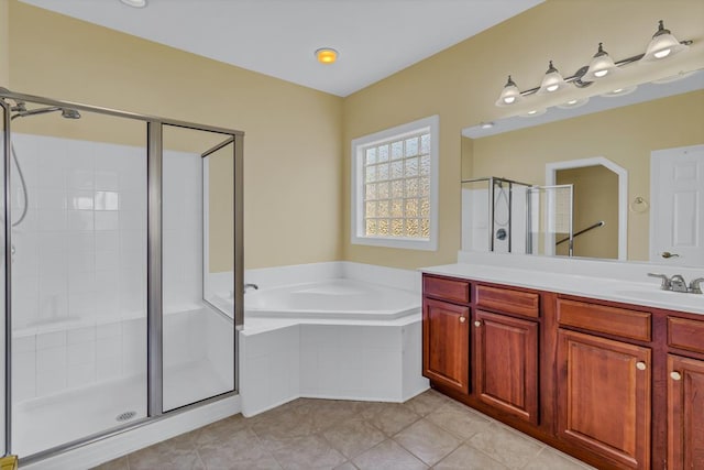 full bath with vanity, tile patterned floors, a stall shower, and a garden tub