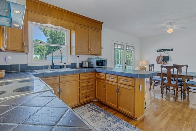 4058 Irvington Rd, Irvington, VA 22480 - kitchen with tile counters, kitchen peninsula, and a healthy amount of sunlight