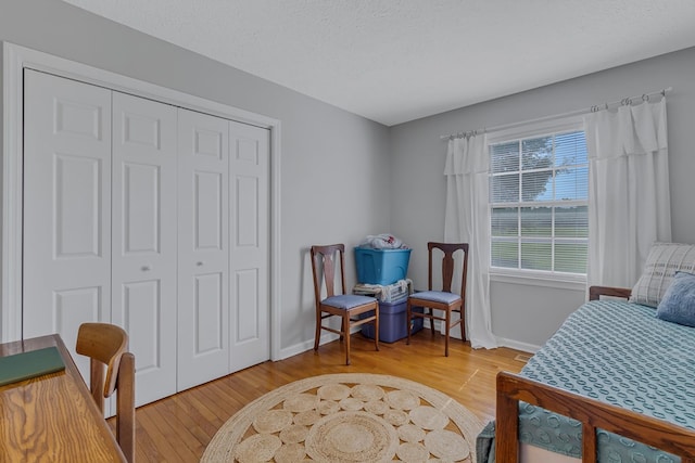 4058 Irvington Rd, Irvington, VA 22480 - bedroom with a textured ceiling, wood-type flooring, and a closet