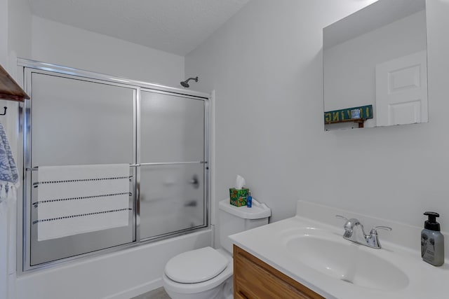 4058 Irvington Rd, Irvington, VA 22480 - full bathroom featuring shower / bath combination with glass door, vanity, toilet, and a textured ceiling