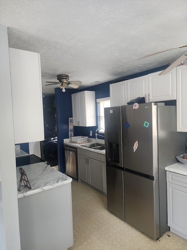 kitchen featuring a sink, stainless steel appliances, light floors, and light countertops