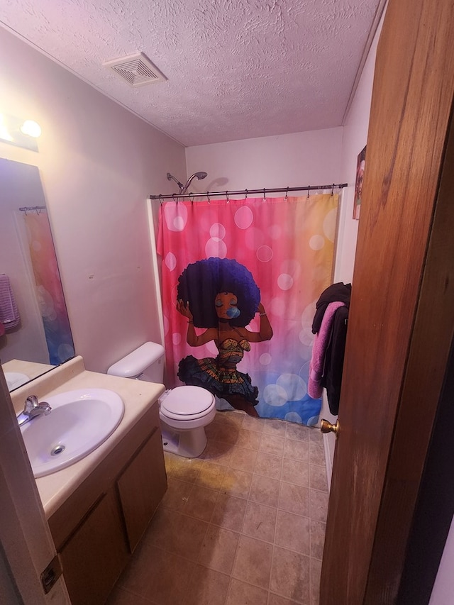 bathroom with visible vents, toilet, vanity, a shower with curtain, and a textured ceiling