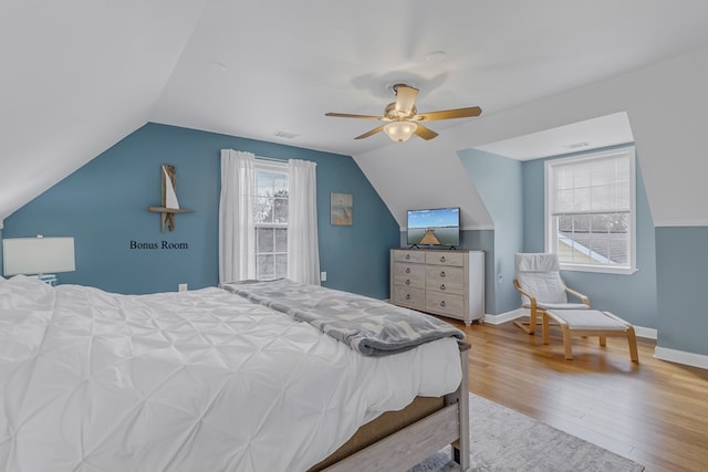 bedroom with hardwood / wood-style flooring, ceiling fan, and lofted ceiling