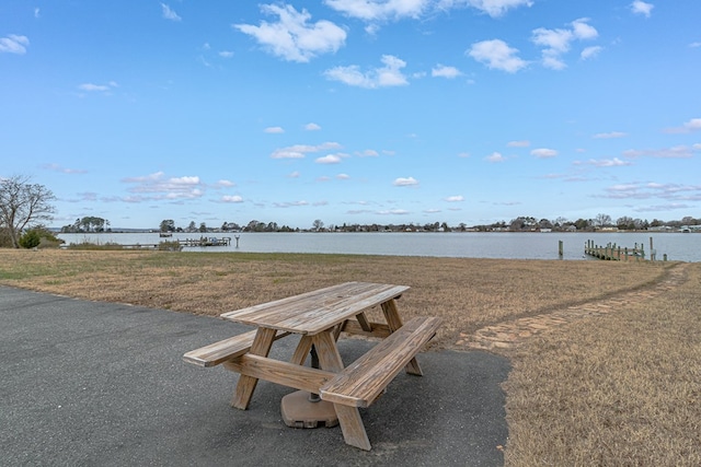 view of property's community featuring a yard and a water view