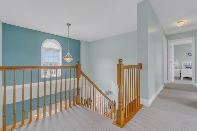 hall featuring light colored carpet