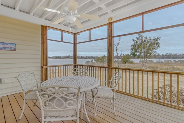 sunroom / solarium featuring ceiling fan and a water view