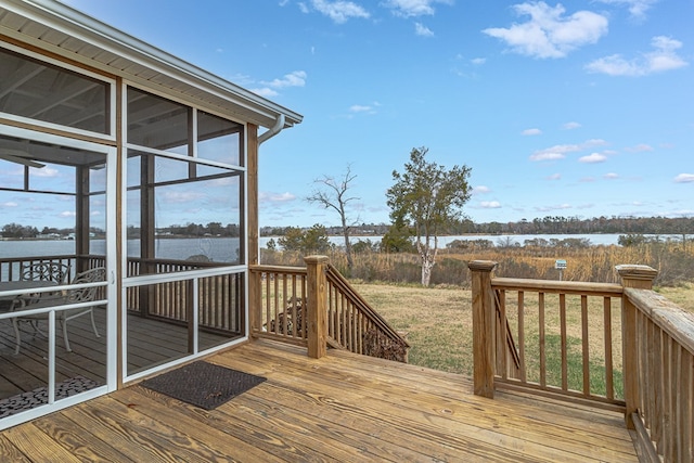 wooden deck featuring a water view and a sunroom