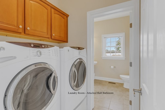 laundry room with light tile patterned flooring, cabinets, and independent washer and dryer