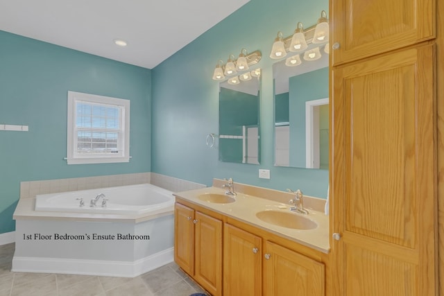 bathroom featuring a washtub, vanity, and tile patterned floors