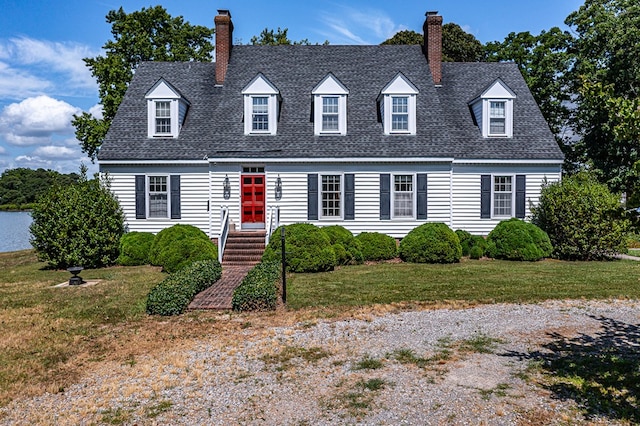 cape cod home with a front yard