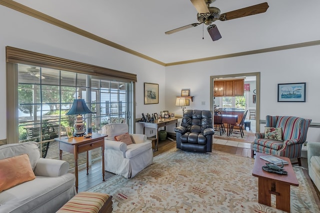 living room with ceiling fan and ornamental molding