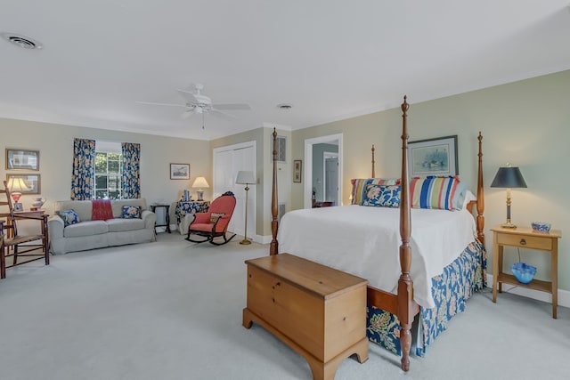 bedroom featuring ceiling fan, a closet, and light colored carpet