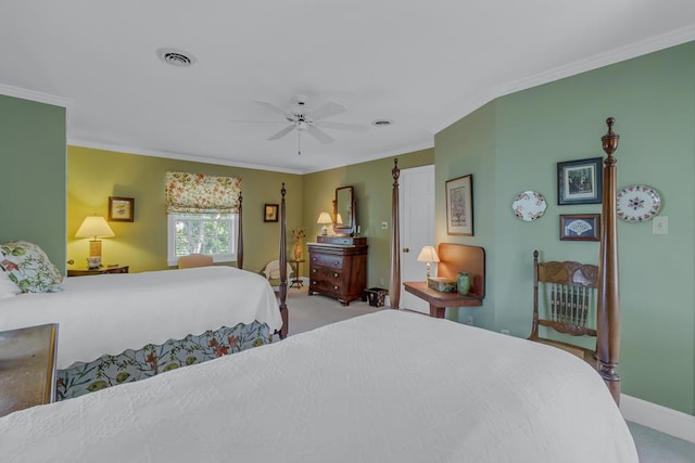 carpeted bedroom with ceiling fan and crown molding