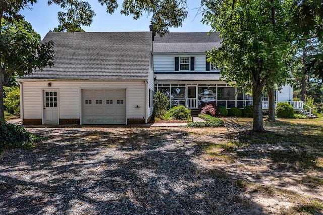 front of property with a sunroom and a garage