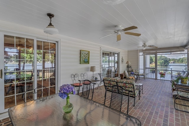 sunroom / solarium with ceiling fan and wood ceiling