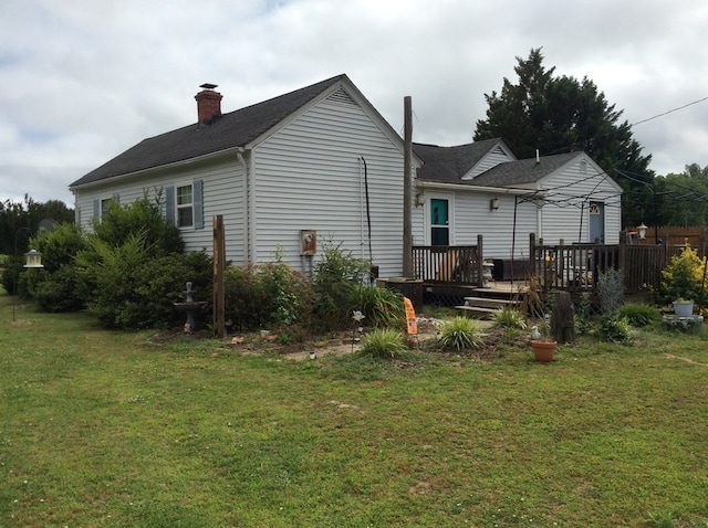 421 Totuskey Church Rd, Warsaw, VA 22572 - rear view of property featuring a yard, a deck, a chimney, and a shingled roof