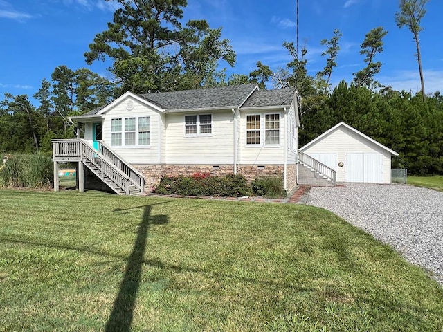 view of front of house with an outbuilding, a front yard, and a garage