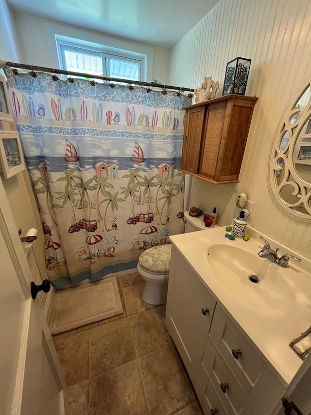 bathroom with vanity, toilet, and walk in shower