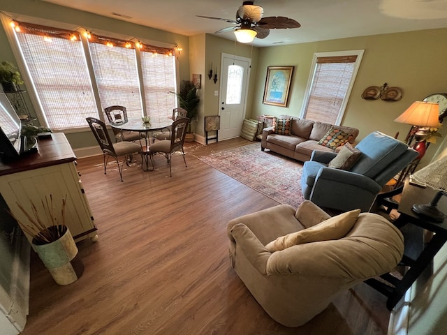 living room featuring ceiling fan and wood-type flooring