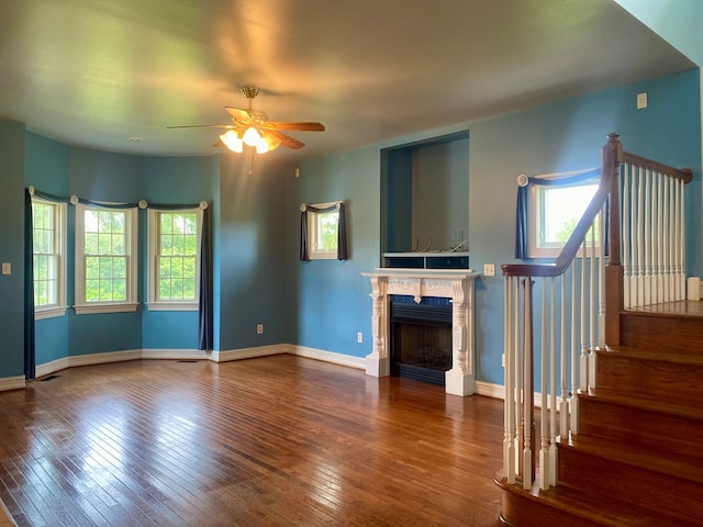 3150 Northumberland Hwy, Lottsburg, VA 22511 - unfurnished living room with a ceiling fan, hardwood / wood-style floors, stairway, and a fireplace