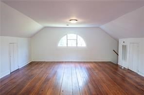 525 Main St, Mathews, VA 23109 - additional living space with baseboards, lofted ceiling, and hardwood / wood-style floors