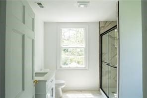 525 Main St, Mathews, VA 23109 - full bath with a healthy amount of sunlight, vanity, a shower stall, and toilet