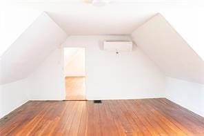 525 Main St, Mathews, VA 23109 - bonus room with wood-type flooring, a wall unit AC, and lofted ceiling