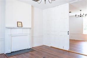 525 Main St, Mathews, VA 23109 - interior space featuring an inviting chandelier, wainscoting, wood finished floors, and a decorative wall