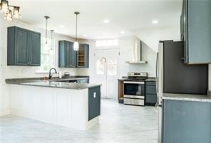 525 Main St, Mathews, VA 23109 - kitchen featuring stainless steel electric stove, exhaust hood, a peninsula, and a healthy amount of sunlight