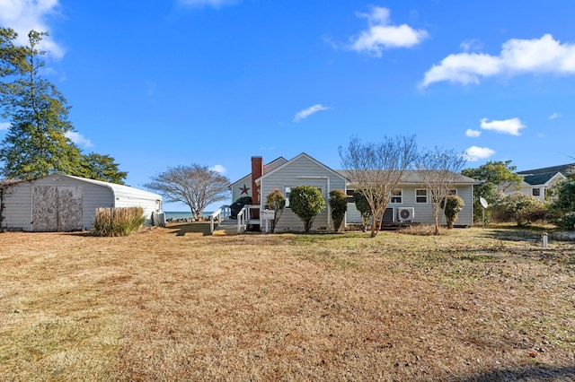 back of property featuring a yard and a carport