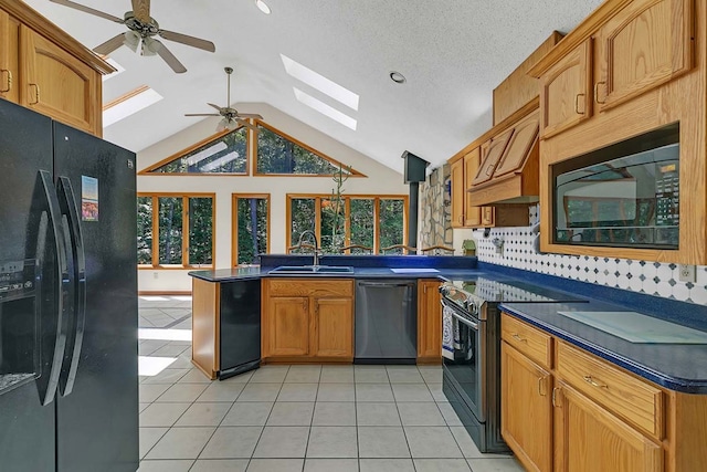 10114 New Hope Ct, Gloucester, VA 23061 - kitchen with black appliances, a skylight, a ceiling fan, dark countertops, and a peninsula