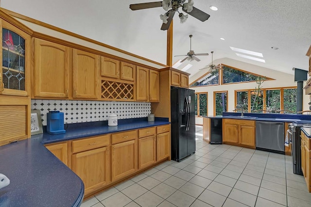 10114 New Hope Ct, Gloucester, VA 23061 - kitchen with black fridge, stainless steel dishwasher, ceiling fan, a skylight, and lofted ceiling