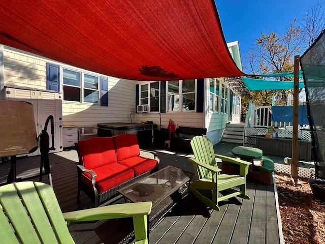 deck featuring a jacuzzi and an outdoor living space