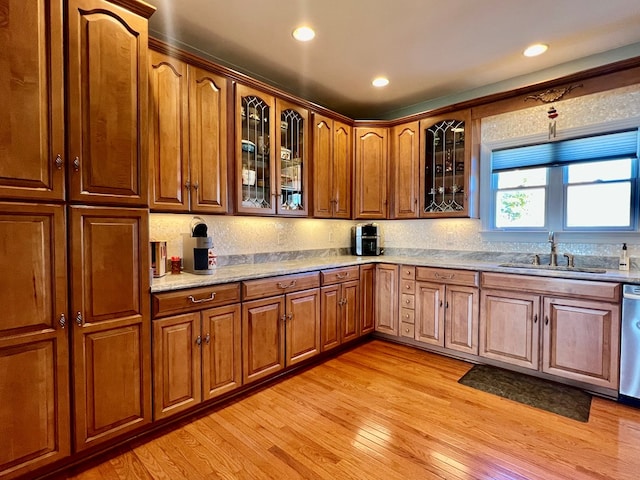 kitchen with dishwasher, light hardwood / wood-style floors, and sink