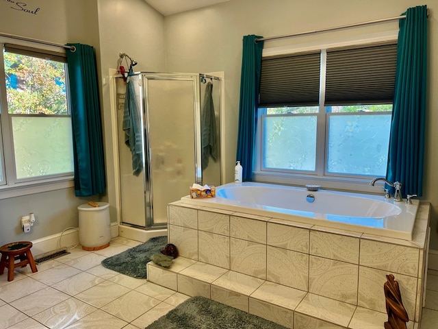 bathroom with a wealth of natural light, tile patterned flooring, and shower with separate bathtub