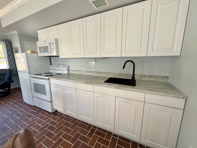 kitchen featuring sink, white cabinets, white appliances, and ornamental molding