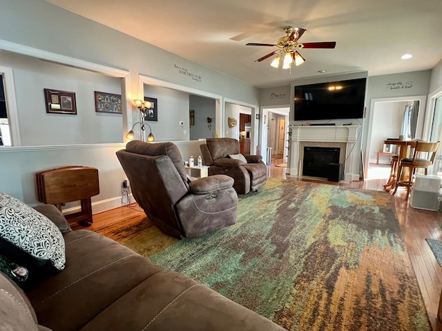 living room featuring hardwood / wood-style floors and ceiling fan