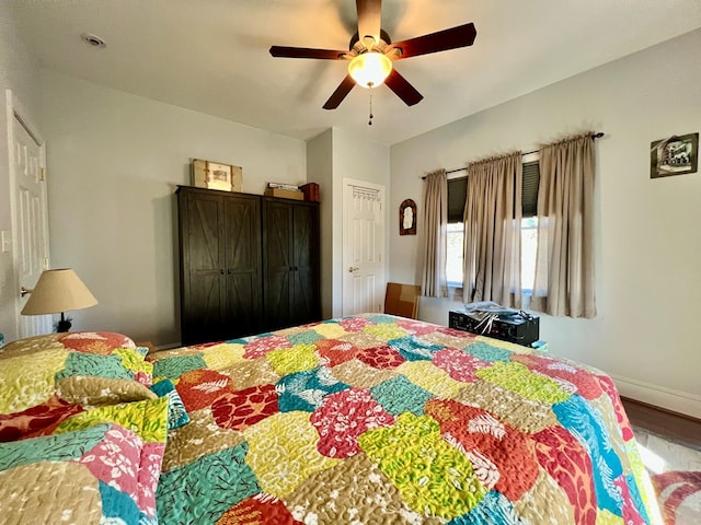 bedroom with hardwood / wood-style flooring and ceiling fan