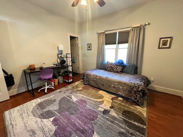 bedroom featuring ceiling fan and dark wood-type flooring