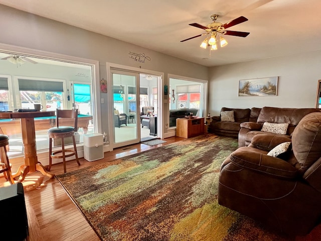 living room featuring hardwood / wood-style flooring and ceiling fan