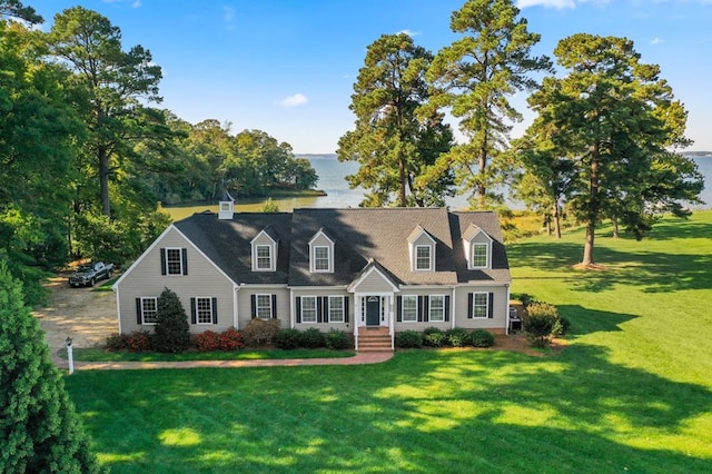 cape cod home featuring a front yard