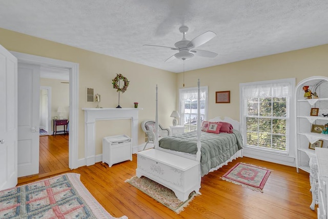 118 Harvey Ln, Heathsville, VA 22473 - bedroom featuring a textured ceiling, light wood-style flooring, and a ceiling fan