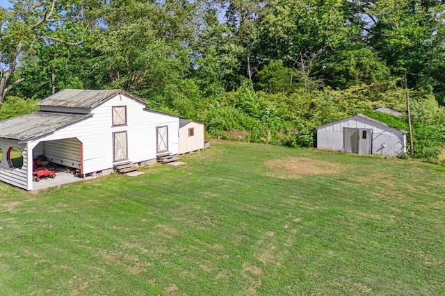 1838 Muddy Gut Rd, Dunnsville, VA 22454 - view of grassy yard with entry steps and an outdoor structure